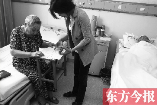 昨日，鄭大五附院二號樓住院部，馬老太寫下委托書，并簽字摁指印委托女兒代理為昏迷老伴解鎖取錢