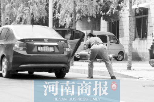鄭州西區(qū)一氧氣廠門前，有人充氣后，將氧氣瓶裝上私家車運走