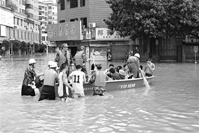 18日，廣東省清遠市陽山縣縣城,消防官兵合力推動沖鋒舟，轉(zhuǎn)移被困學生。新華社發(fā)