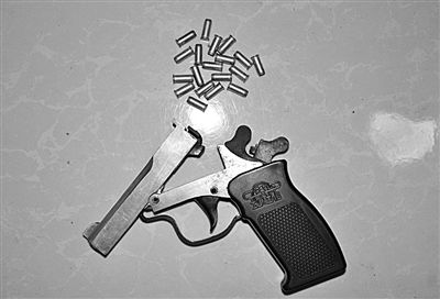 警方從搶劫嫌疑人處起獲的贓款和發(fā)令槍、子彈。警方供圖