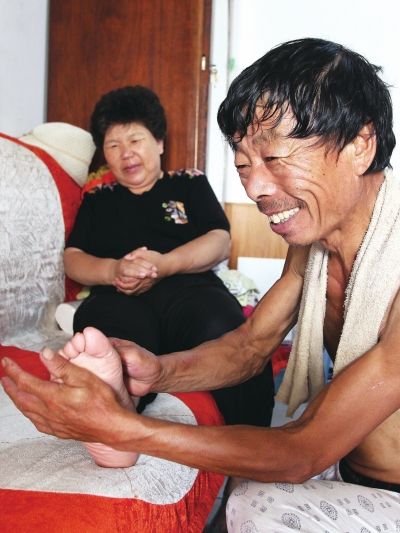 慈成富為老伴按摩。