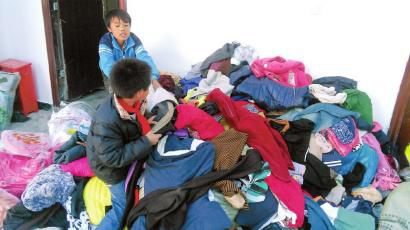 學(xué)生在幫忙整理收到的捐贈衣服。得石中心校供圖