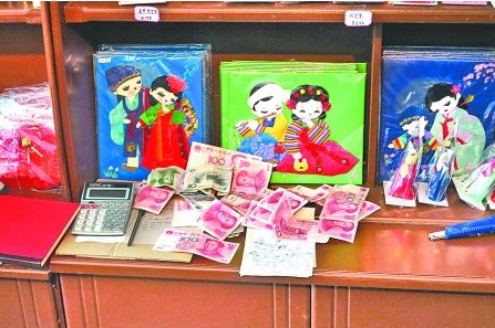 　　2012年6月21日，在朝鮮羅先特別市的一家商店里，柜臺(tái)上散落著一些人民幣。在朝鮮，人民幣比本國
