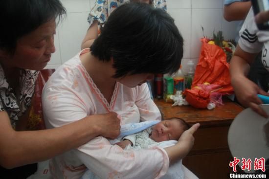 圖為陜西富平“產(chǎn)科醫(yī)生拐賣嬰兒”一案中的被拐嬰兒于8月5日中午在該縣婦幼保健院由當(dāng)?shù)鼐浇挥谄涓改?。張一?攝