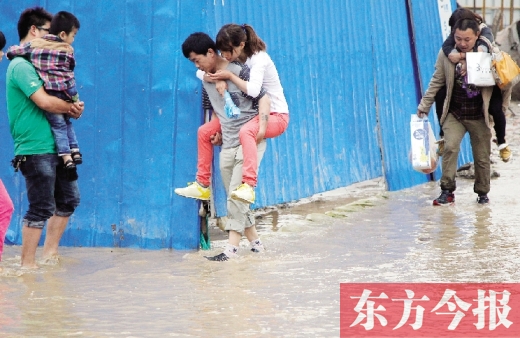 雨后鄭州，“背人過(guò)河”成了一道甜蜜又無(wú)奈的風(fēng)景 東方今報(bào)記者 沈翔 攝